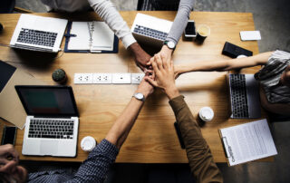 Team of business people stacking hands